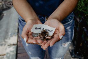 woman holding hands out with change in them