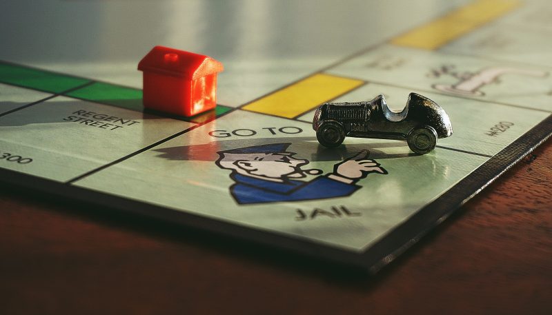 monopoly board with car and house