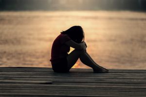 Woman sitting at the boardwalk