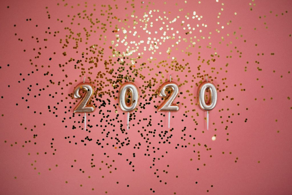 2020 candles on a pink background with glitter