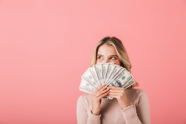 woman fanning money in front of her face