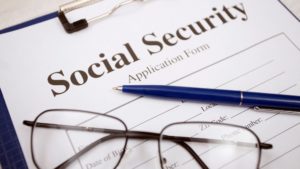 Social Security paperwork with black glasses and pen