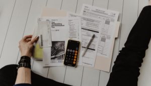 woman looking down at tax documents on the table